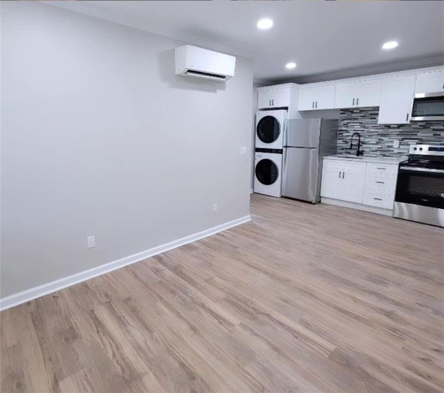 a view of kitchen with a refrigerator and microwave