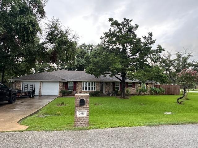 a front view of a house with garden and trees