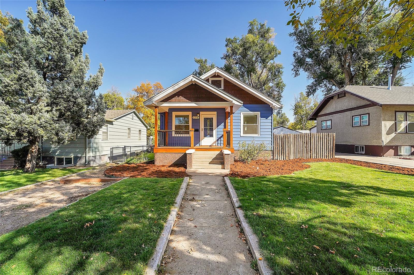 a front view of a house with yard and green space