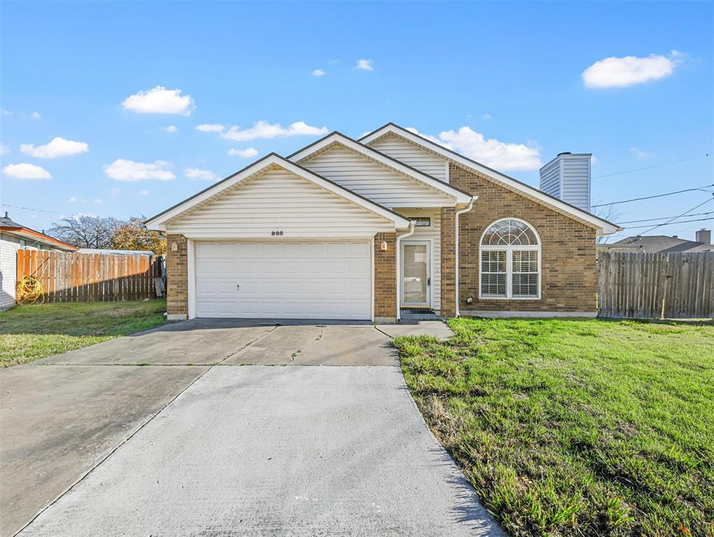 a view of a house with a yard and garage