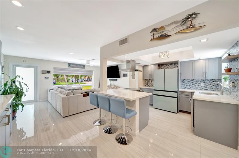 a kitchen with a sink stainless steel appliances and white cabinets