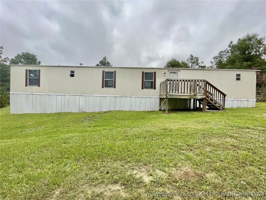 a view of a house with a backyard and a yard