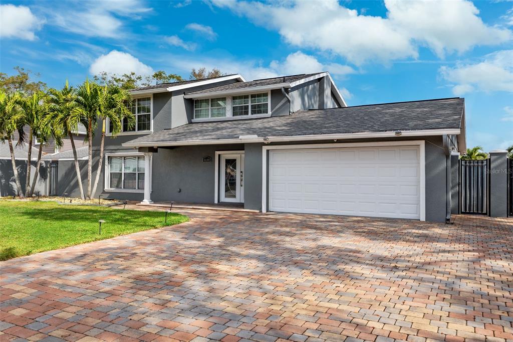 a front view of a house with a yard and garage