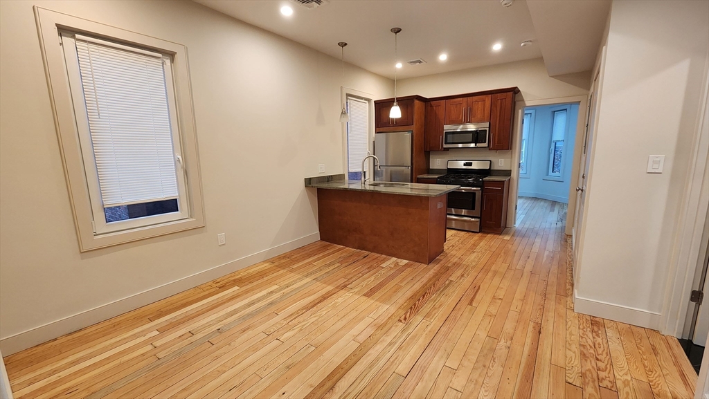 a view of kitchen appliances and wooden floor