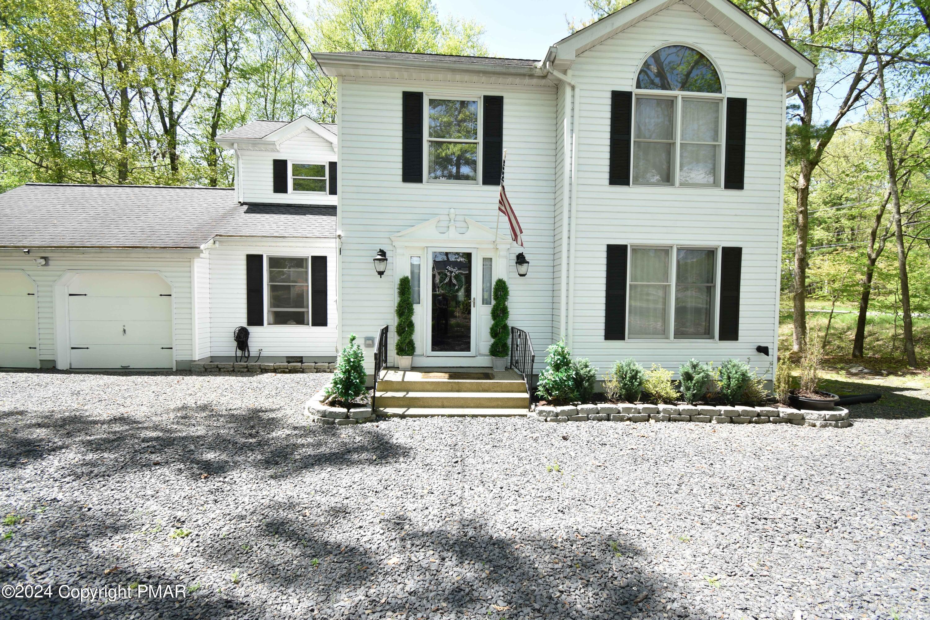 a front view of a house with garden