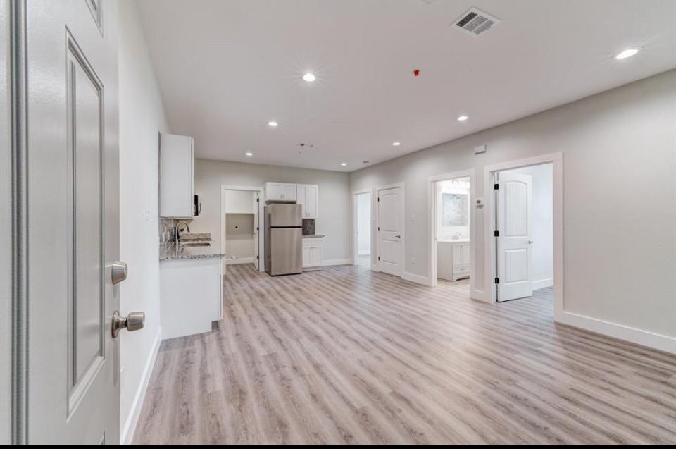 a view of a kitchen with a refrigerator and a microwave