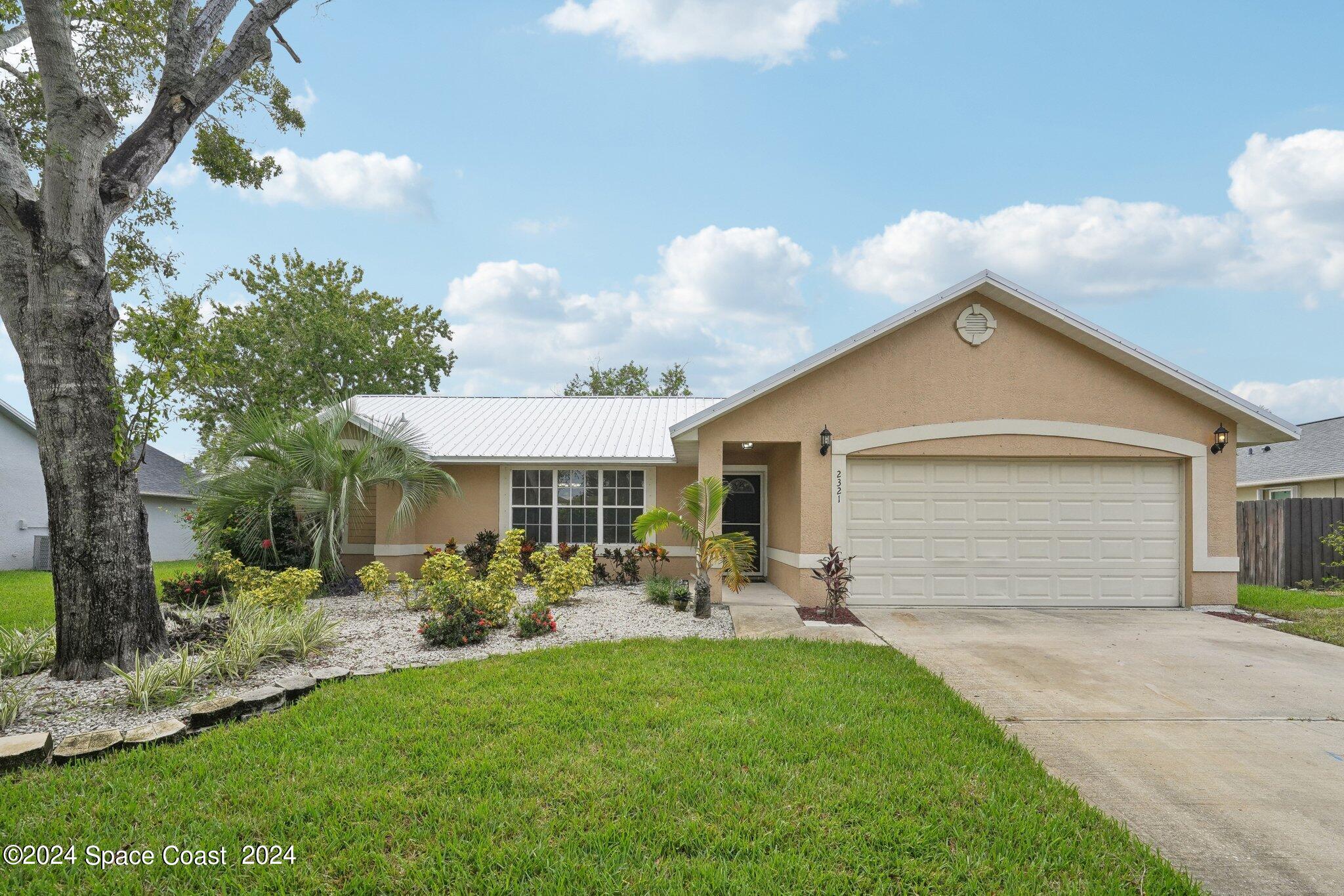 a front view of house with yard and outdoor seating