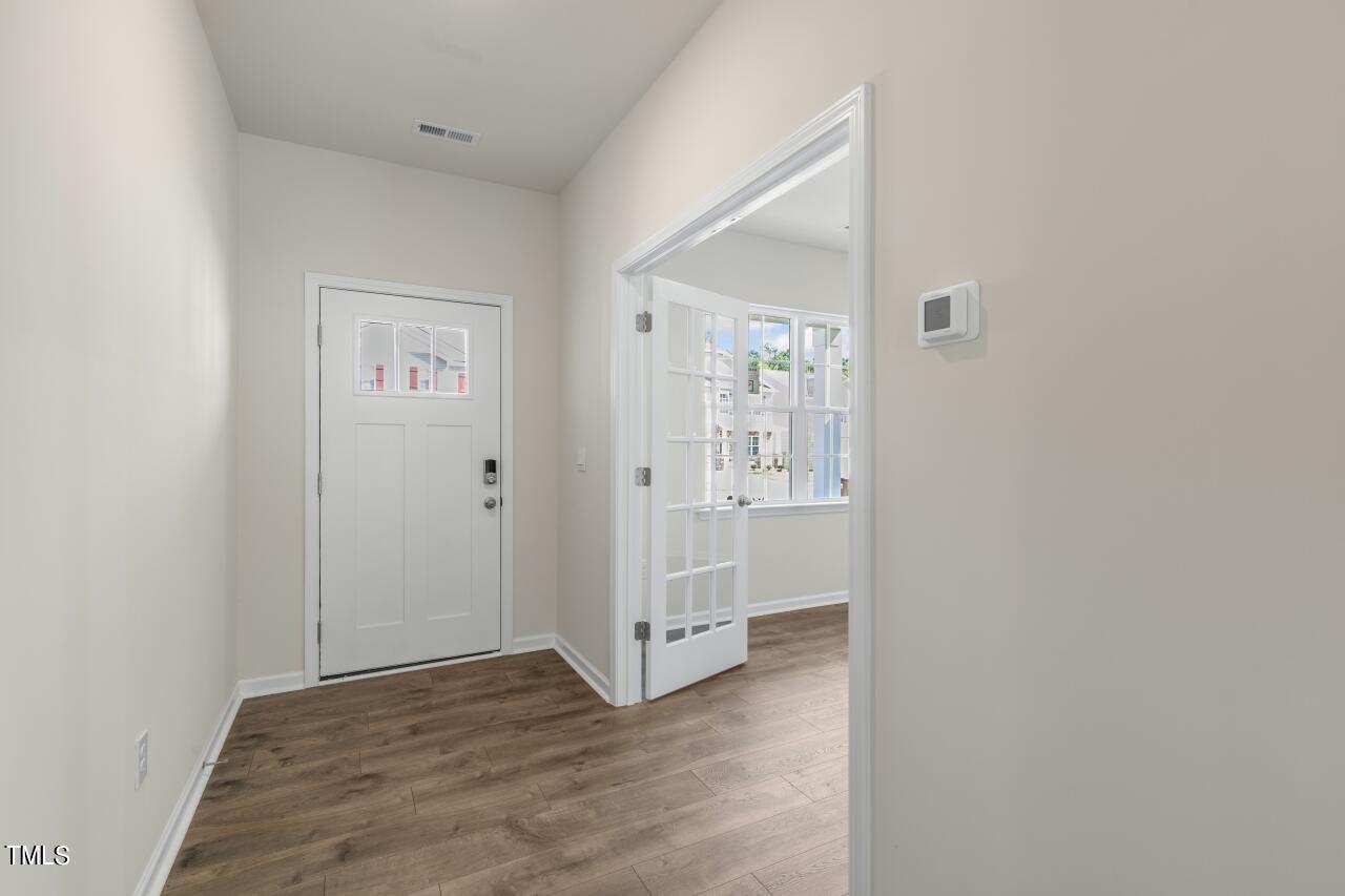 a view of a hallway with wooden floor