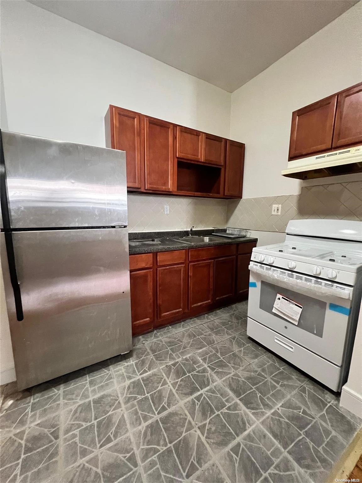 a kitchen with a stove top oven and sink