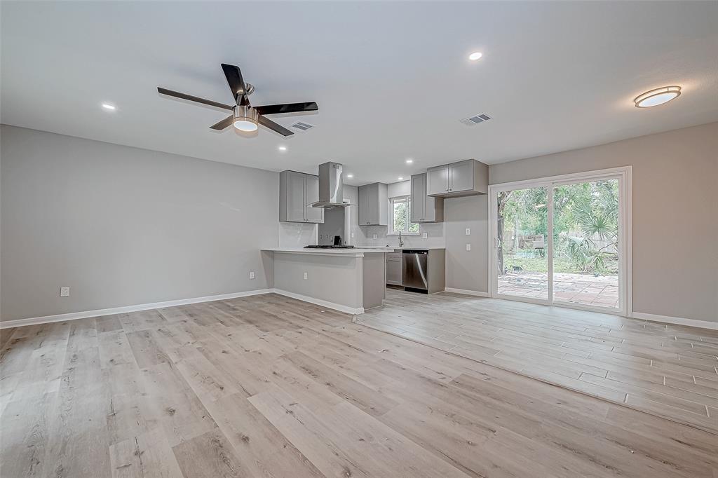 a view of a kitchen with a sink and wooden floor