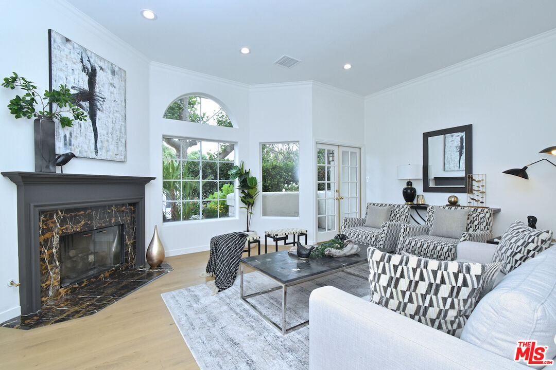 a living room with furniture fireplace and window