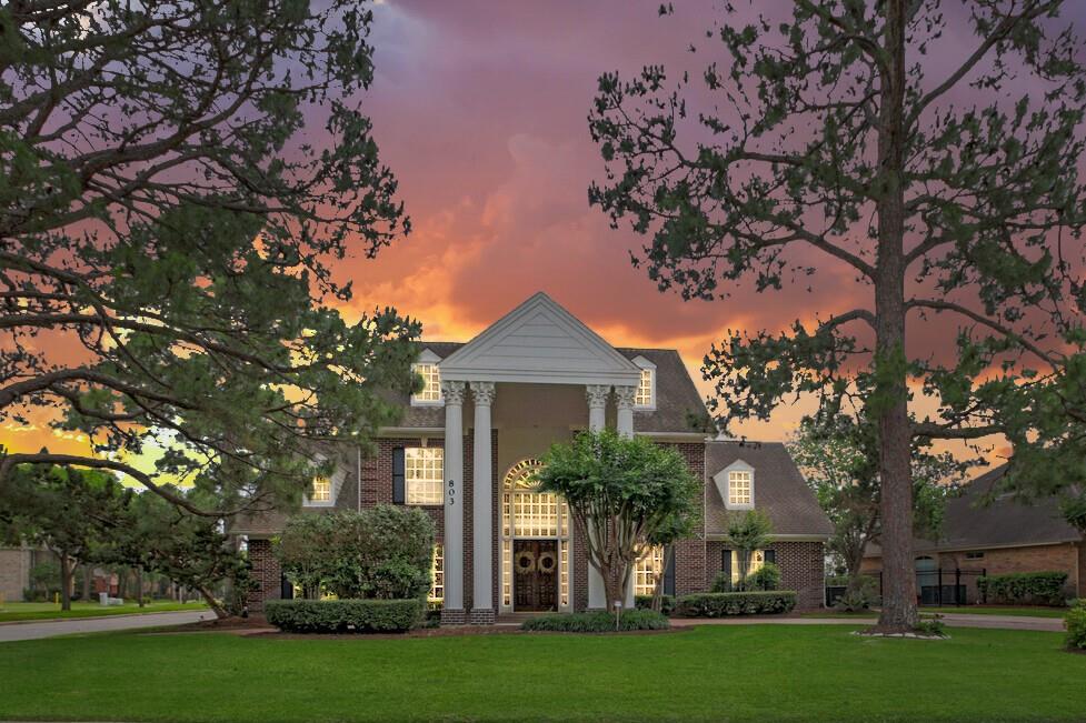 a front view of a house with a garden