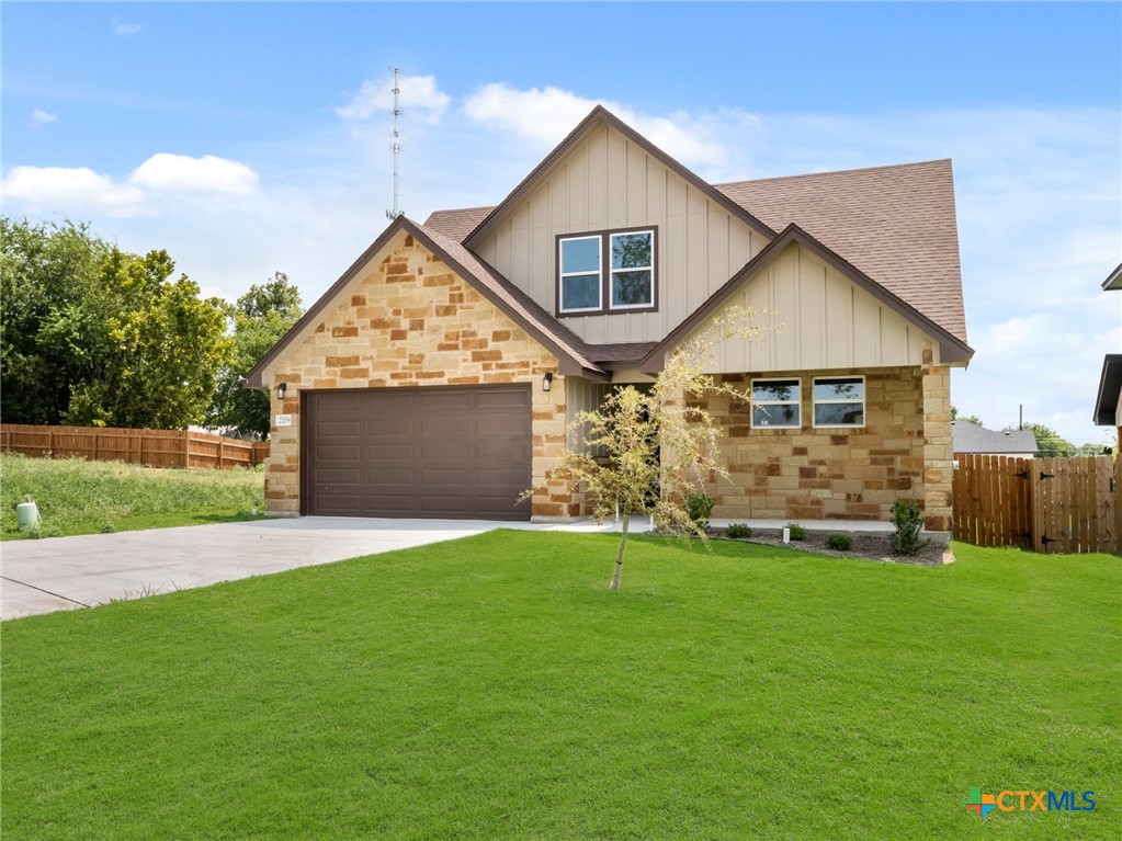 a front view of a house with a yard and garage