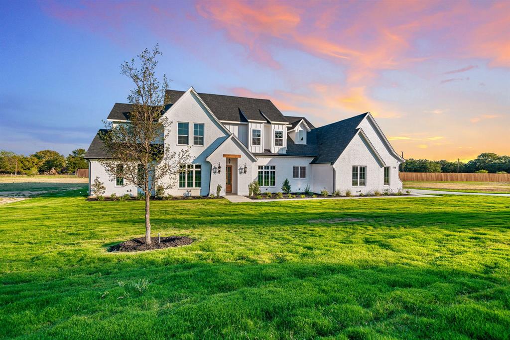 a front view of house with yard and green space