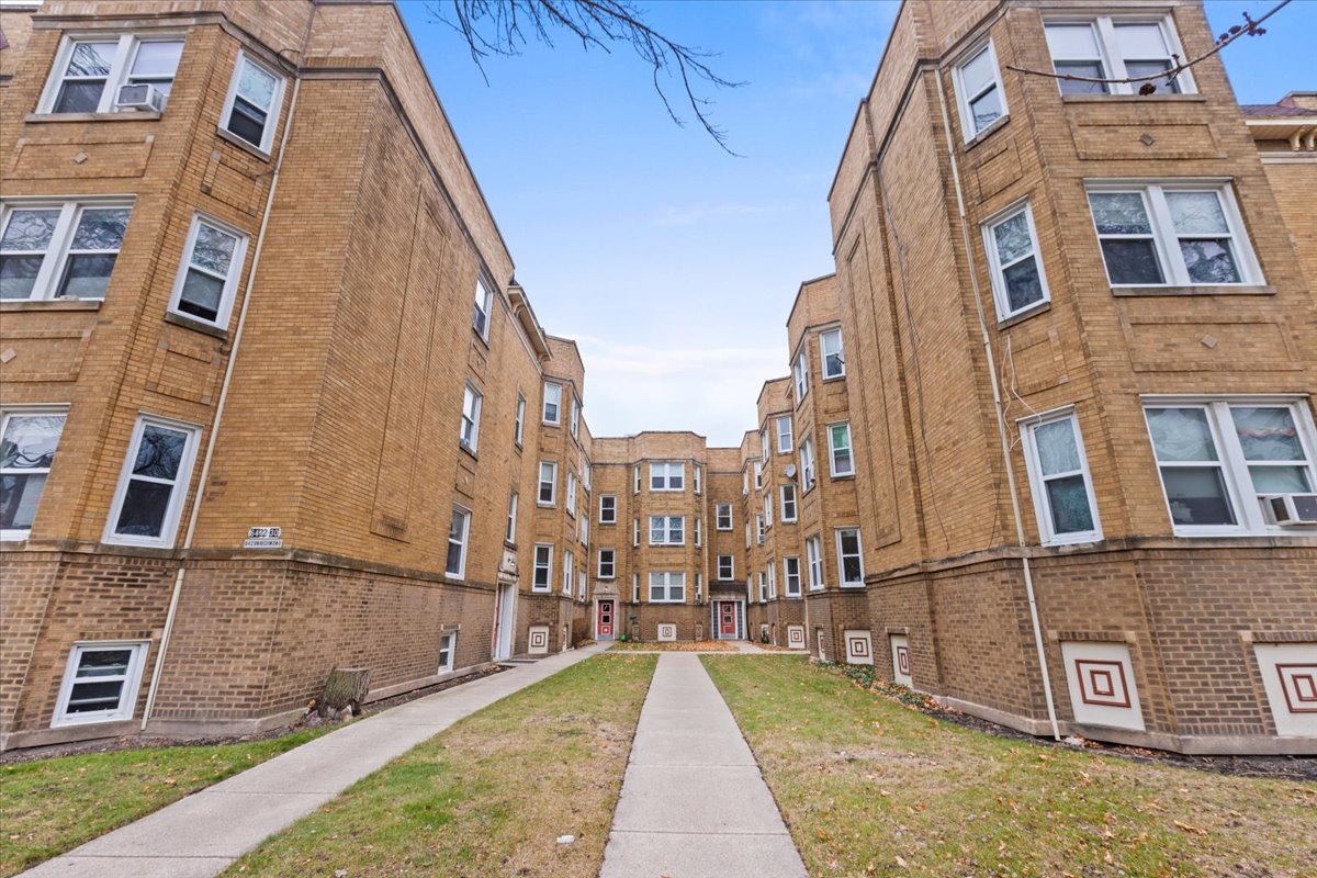 a view of a brick building next to a yard