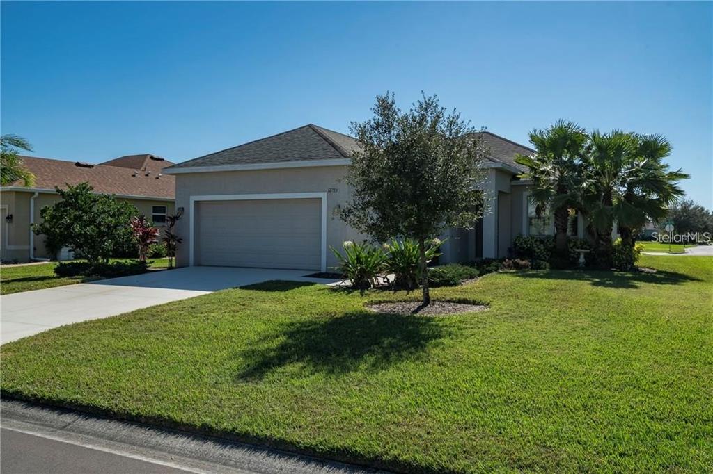 a front view of a house with a garden and yard