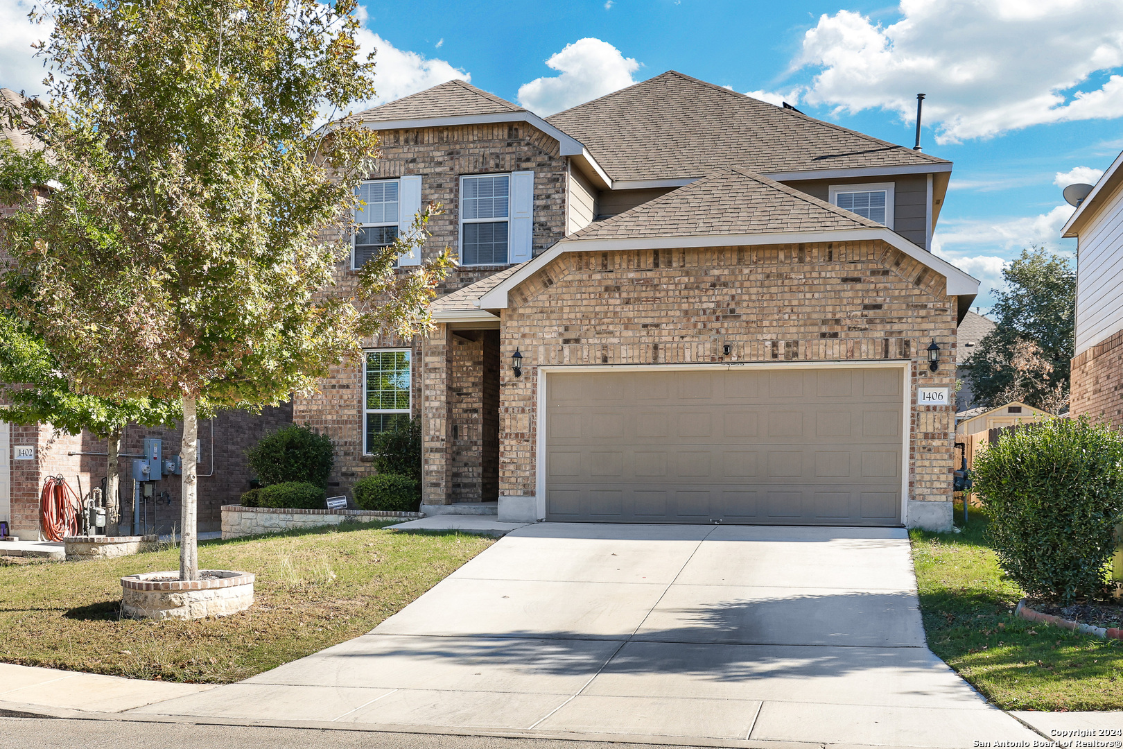 a front view of a house with a yard and garage