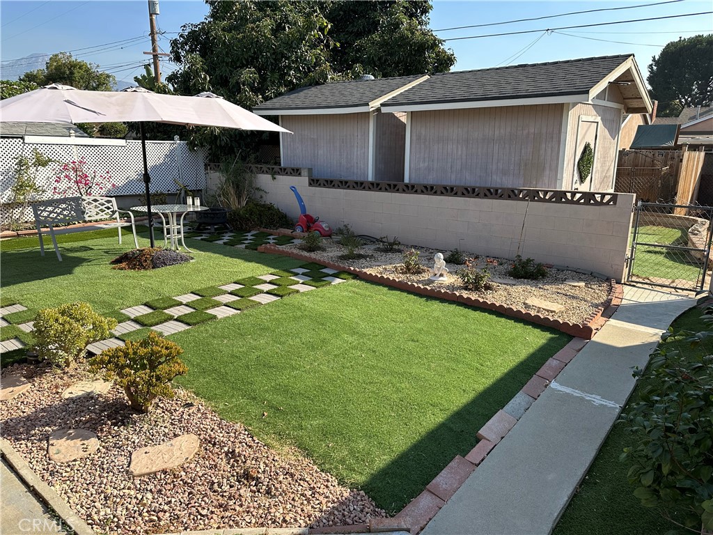 a backyard of a house with yard and outdoor seating