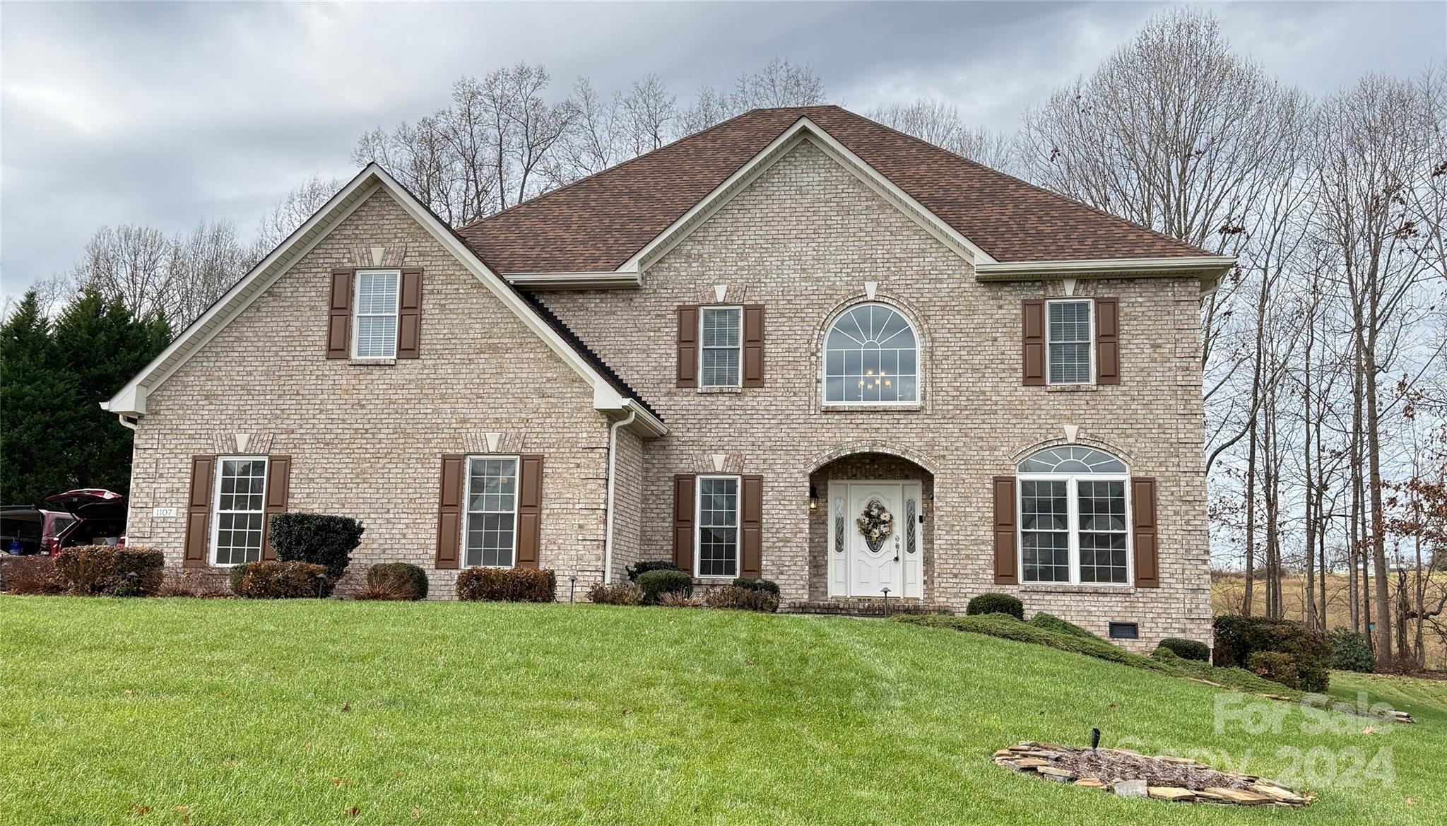 a front view of a house with a garden