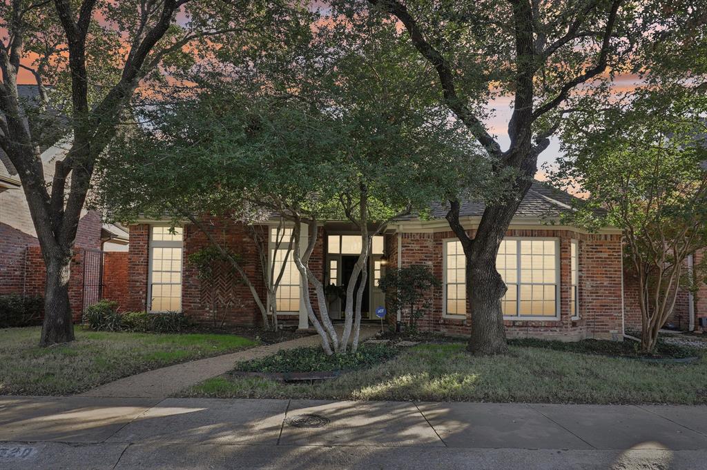 a view of a house with a tree in front of it