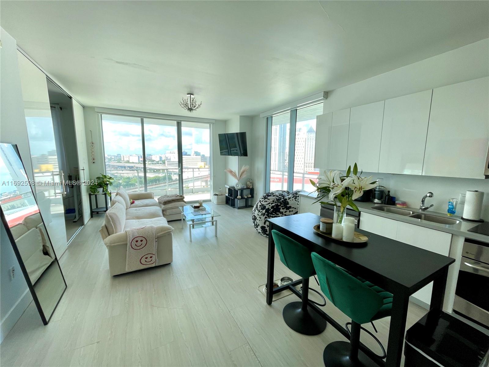 a view of a livingroom with furniture window and wooden floor