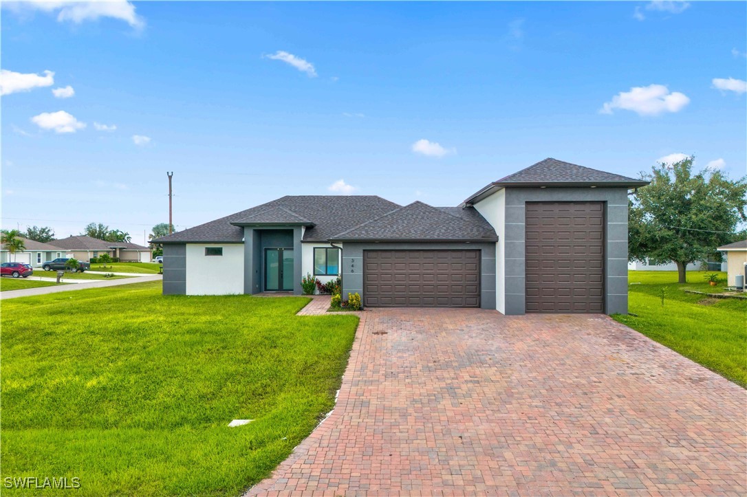 a front view of a house with a yard and garage