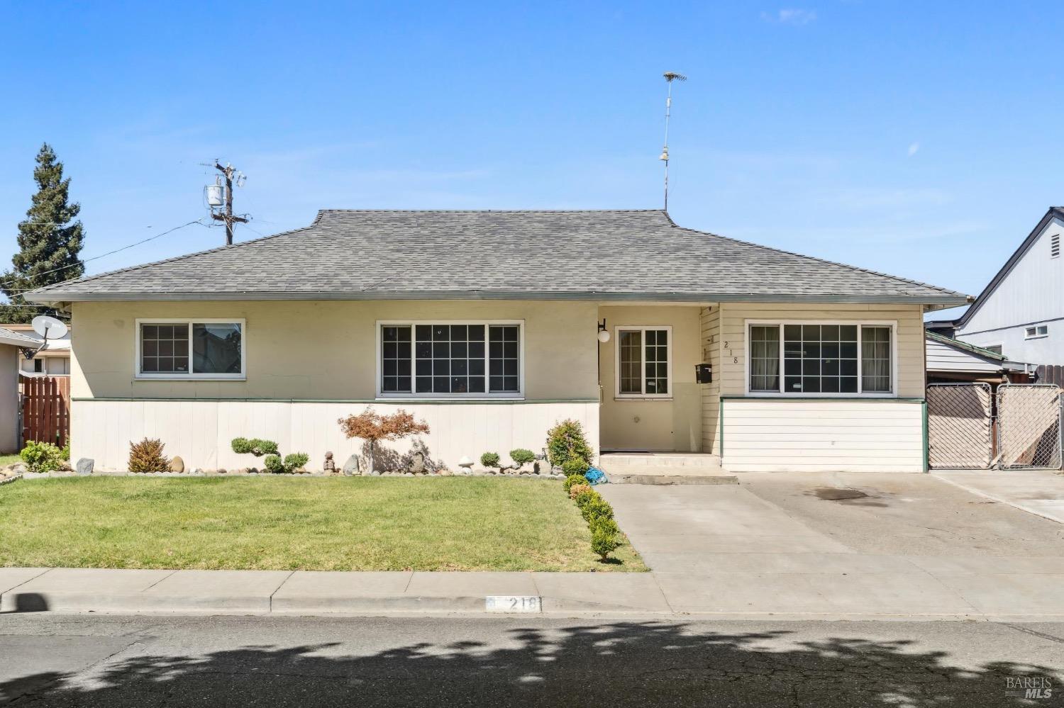 a front view of a house with a yard