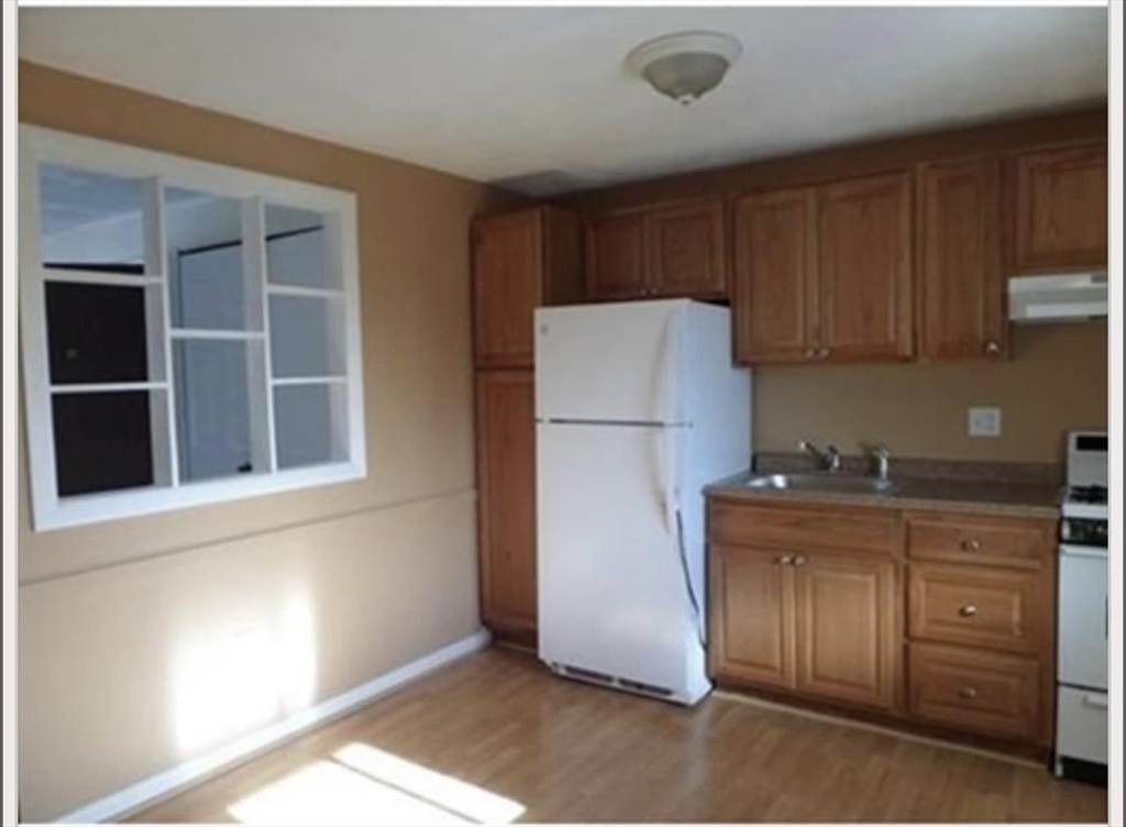 a kitchen with a refrigerator and a sink