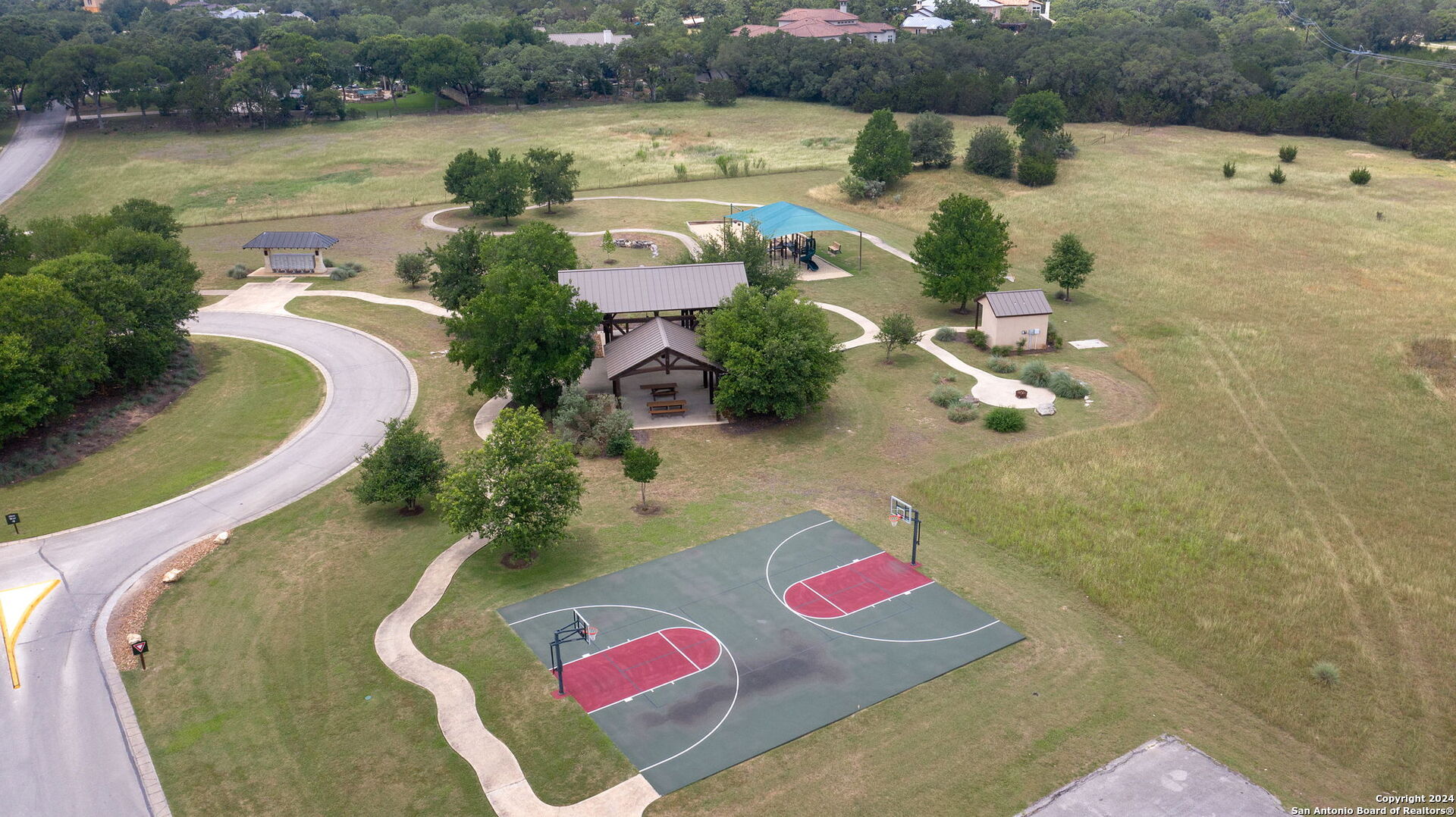 an aerial view of a house with outdoor space and lake view