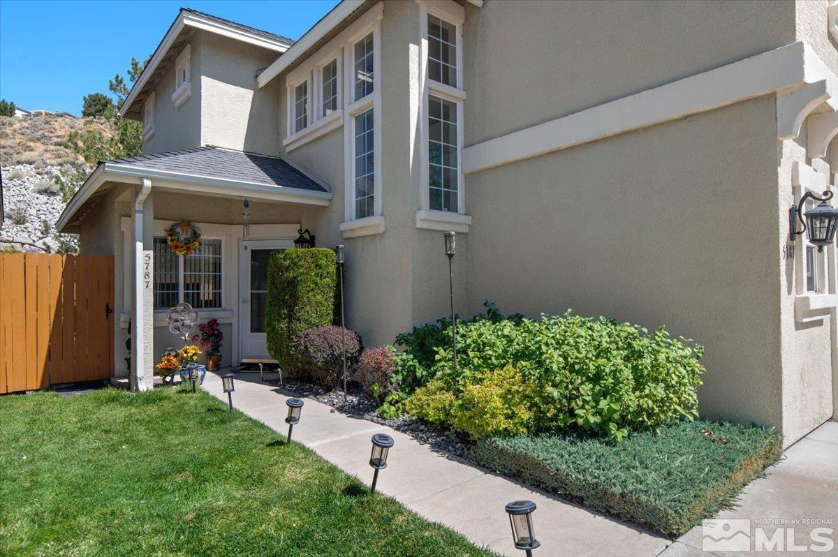 a front view of a house with garden