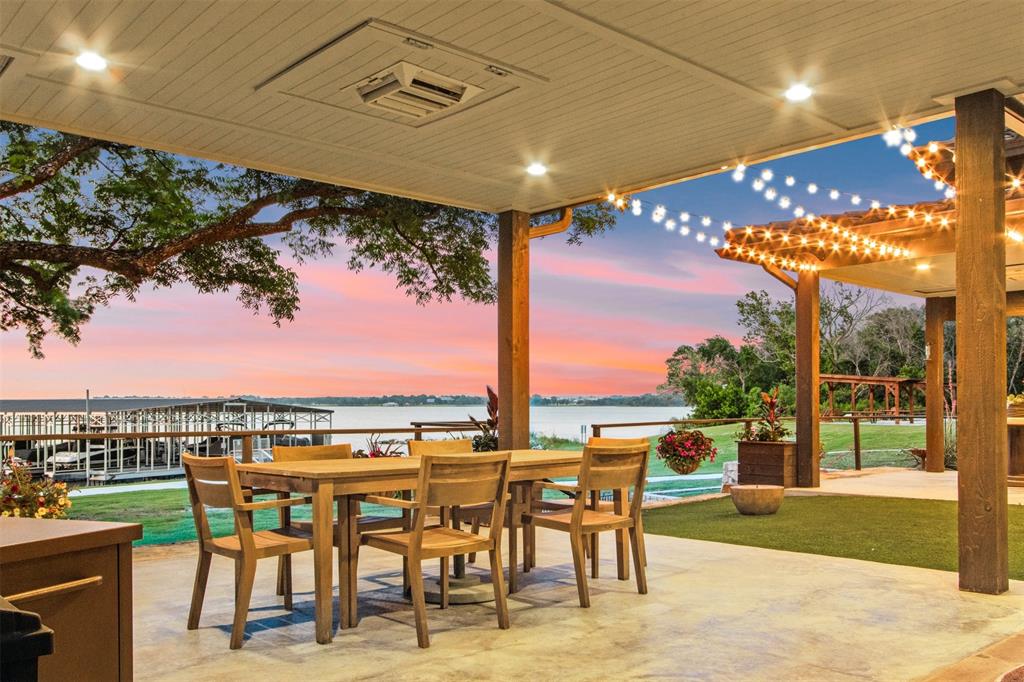 a view of a patio with dining table and chairs with wooden floor