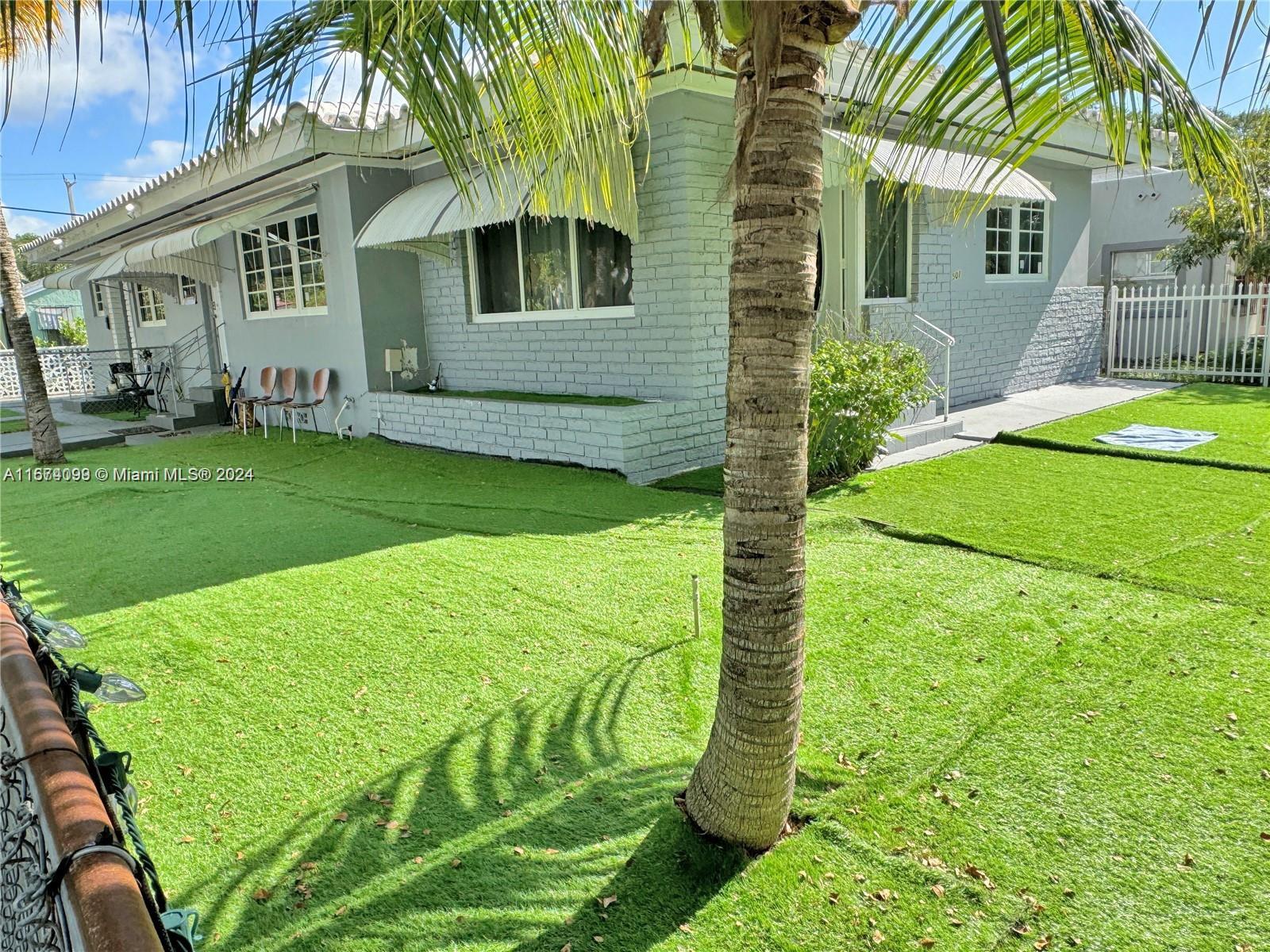 a view of a house with a backyard