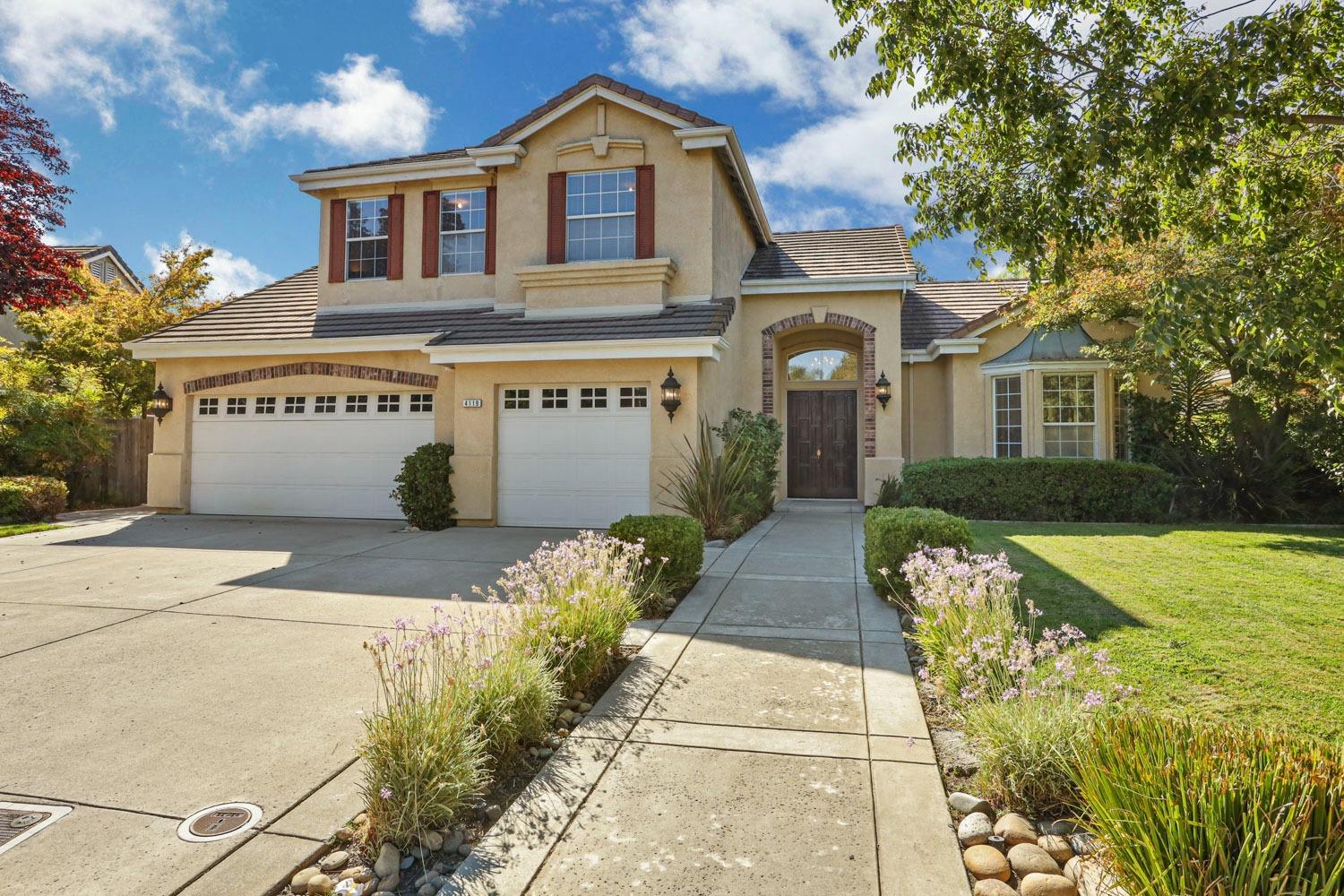 a front view of a house with garden