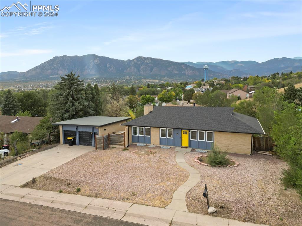 Ranch-style house with a garage, a carport, and a mountain view