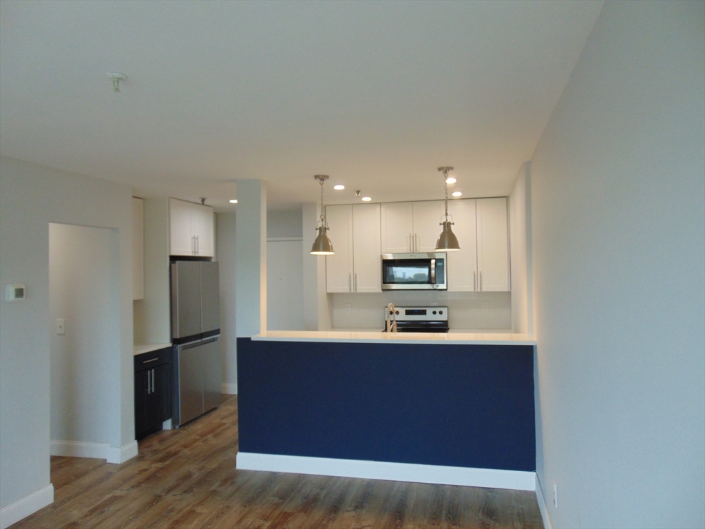 a kitchen with kitchen island a sink appliances and cabinets