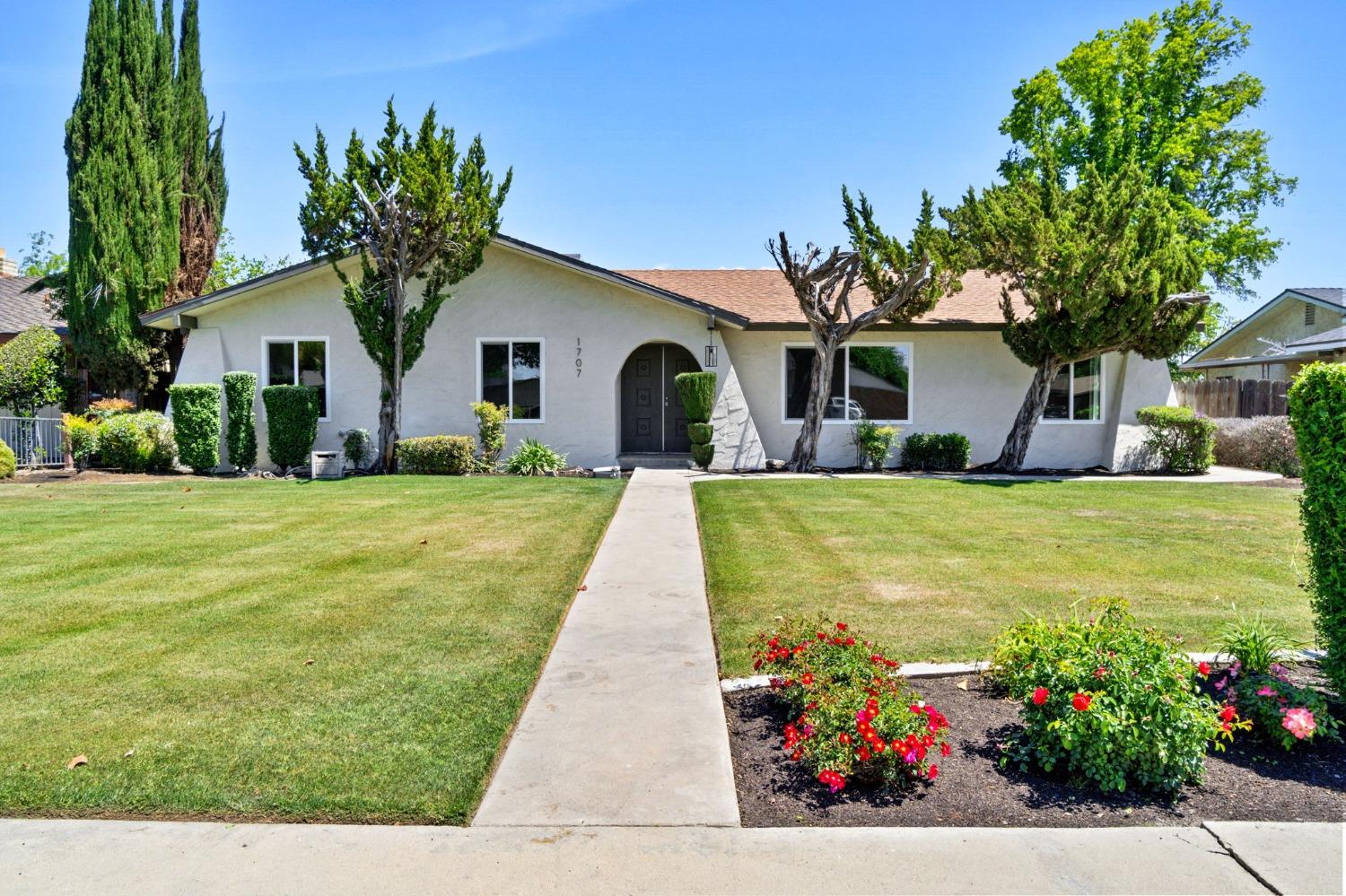 a front view of house with yard and green space