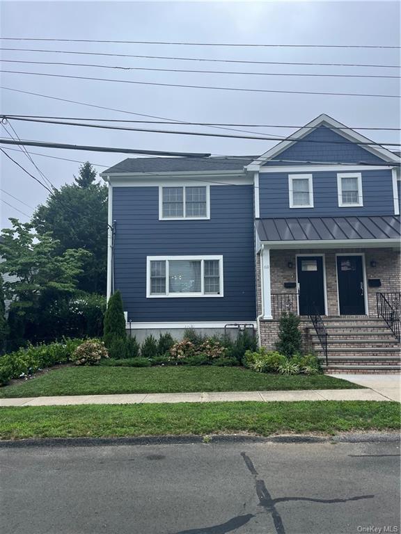 a front view of a house with a yard