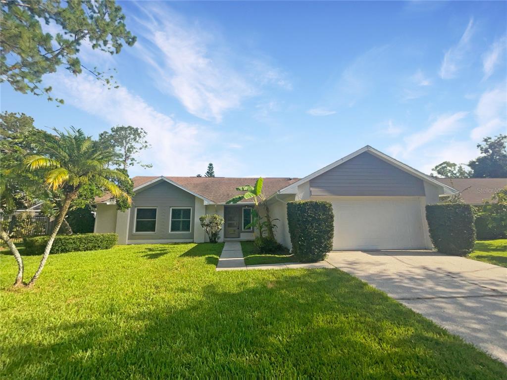 a front view of a house with a garden and yard