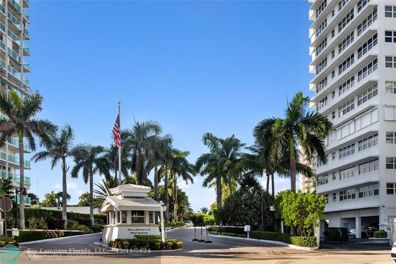 a front view of a building with palm trees