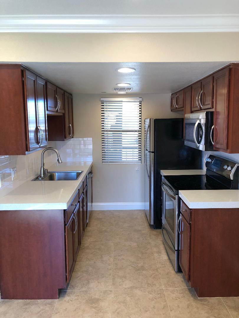 a kitchen that has a sink and a stove in it