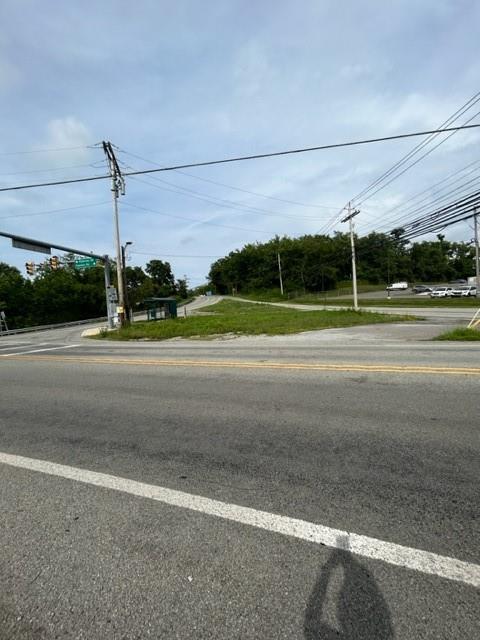 a view of a road with a big yard