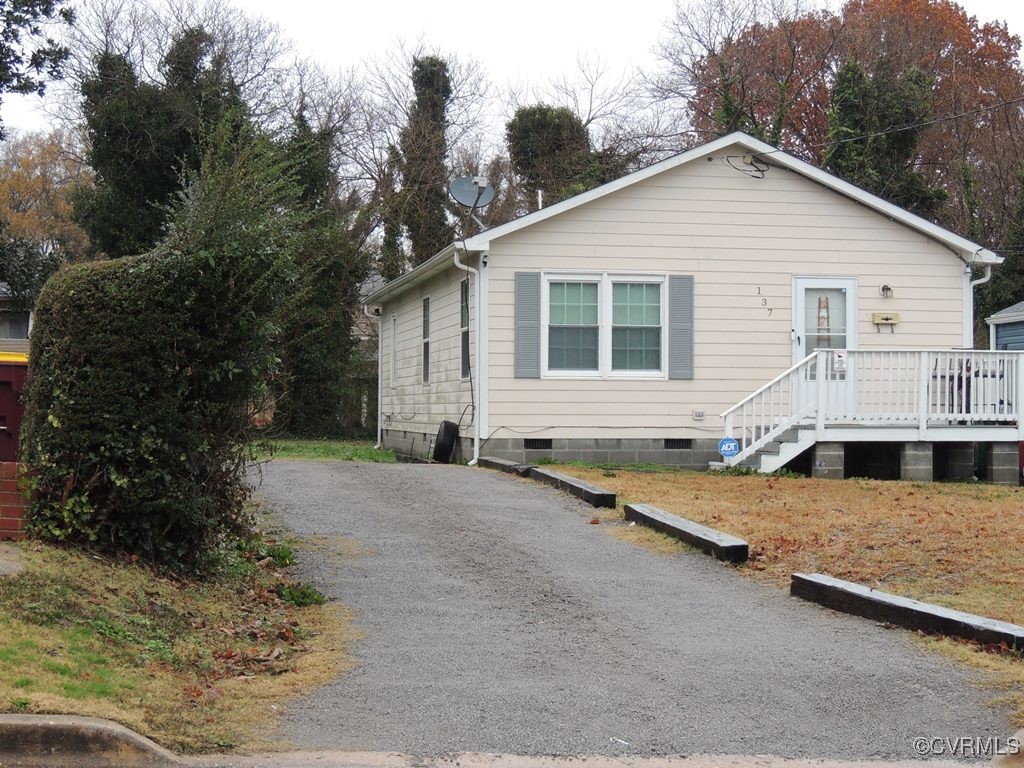 a view of a white house with a yard and outdoor space