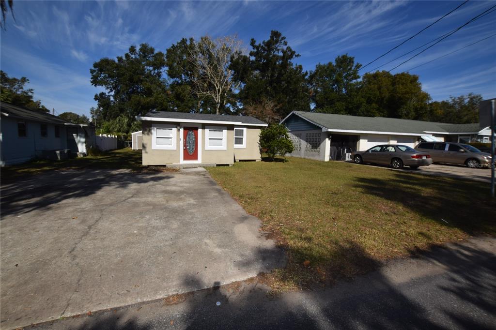 a view of a house with a yard and a garage