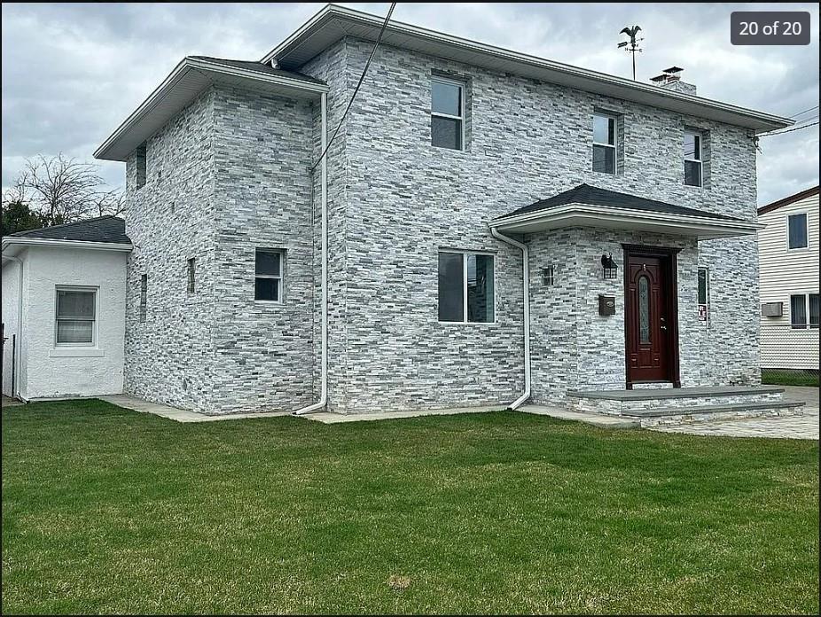 a front view of a house with a yard