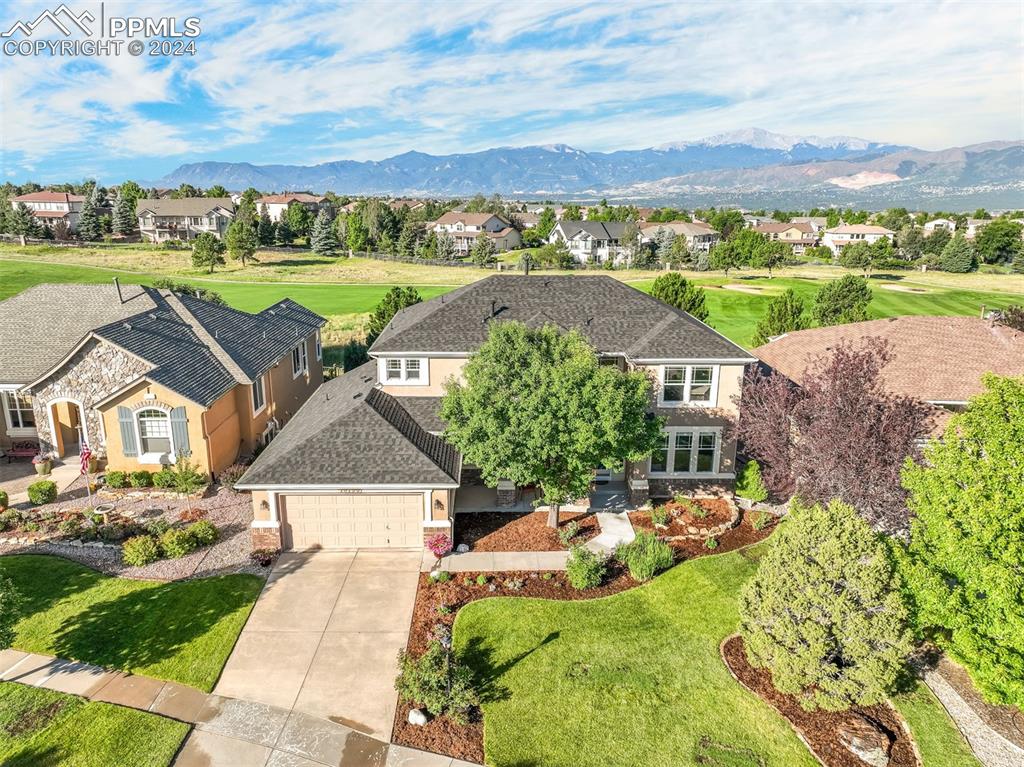 an aerial view of a house with a yard and lake view