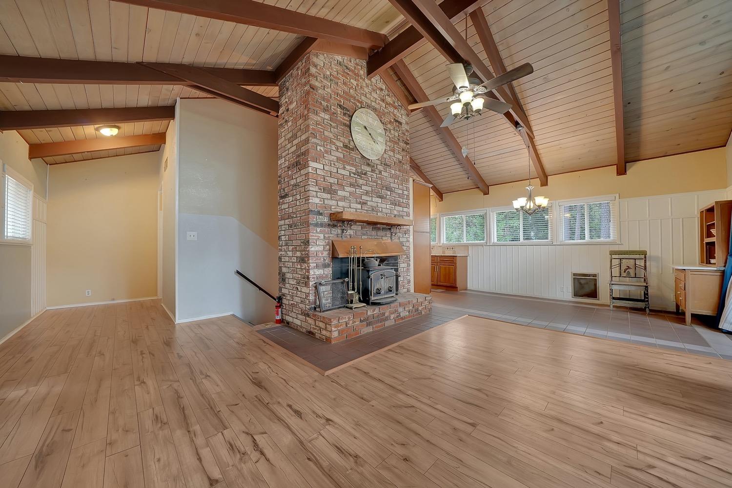 a view of a livingroom with a fireplace and window