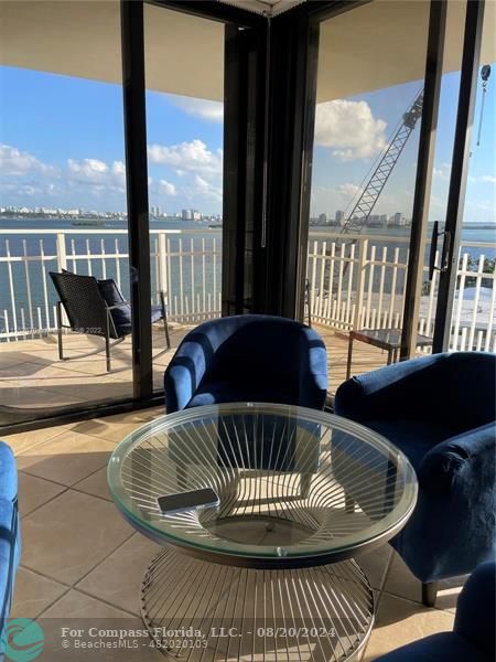 a view of a balcony dining area with furniture