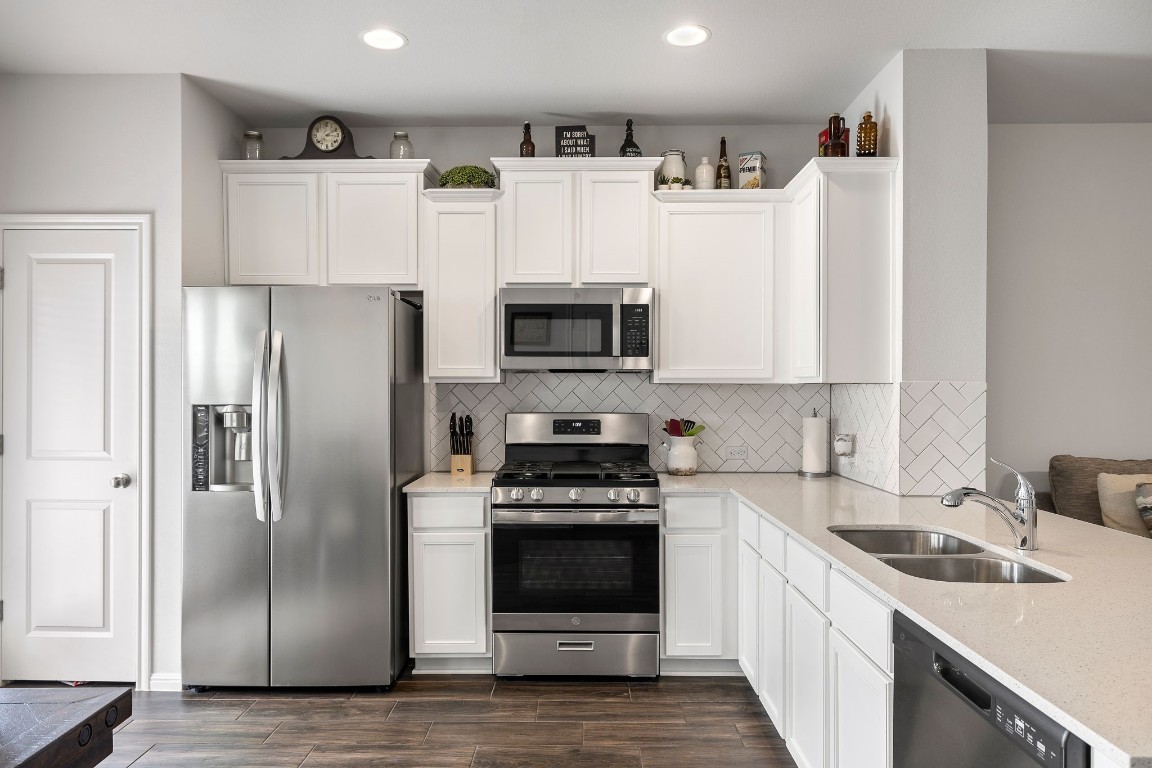 a kitchen with a refrigerator stove and microwave