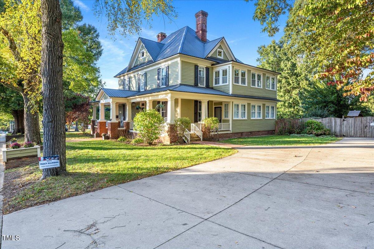 a front view of house with yard and green space