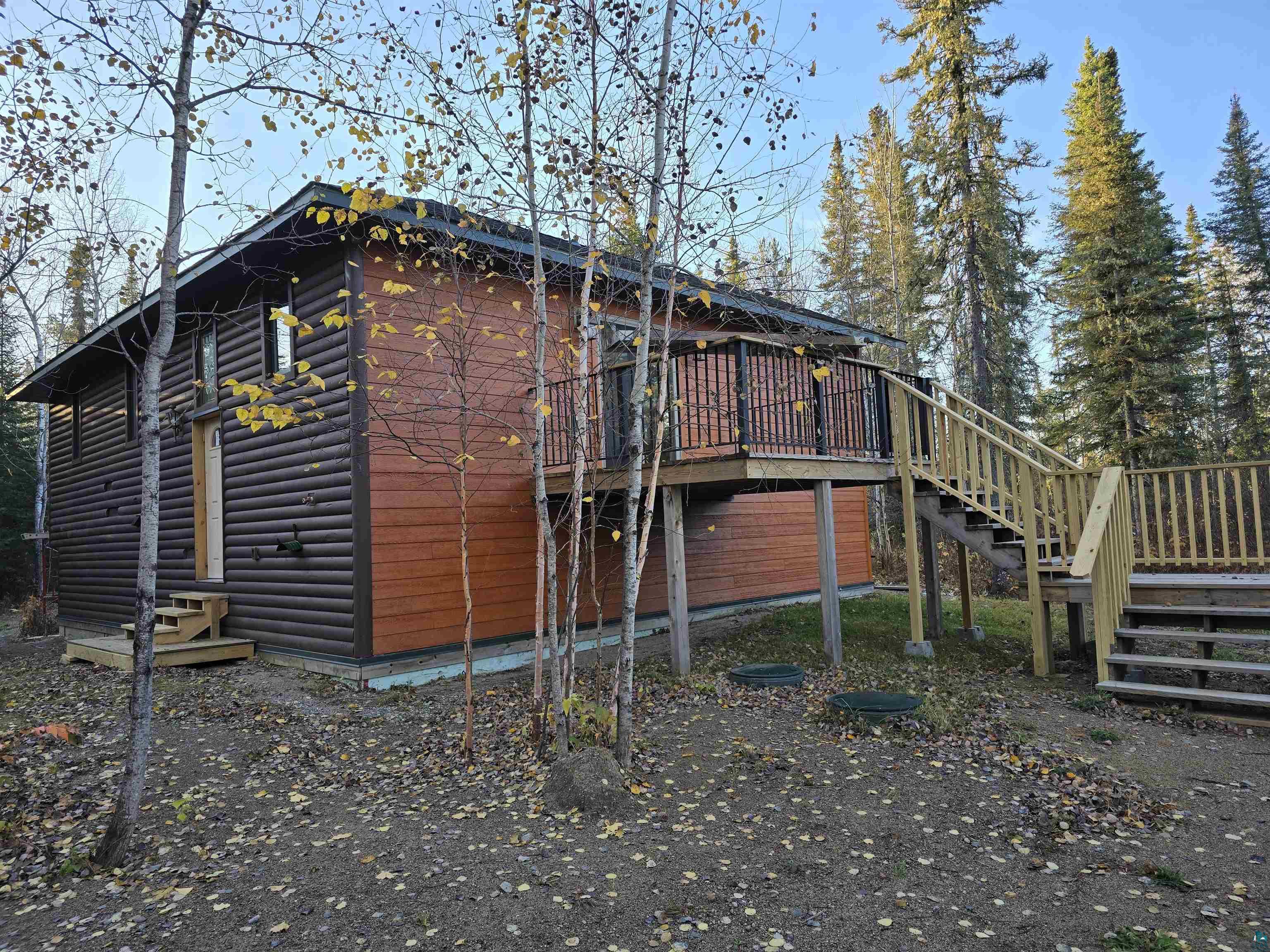 View of side of home featuring a deck